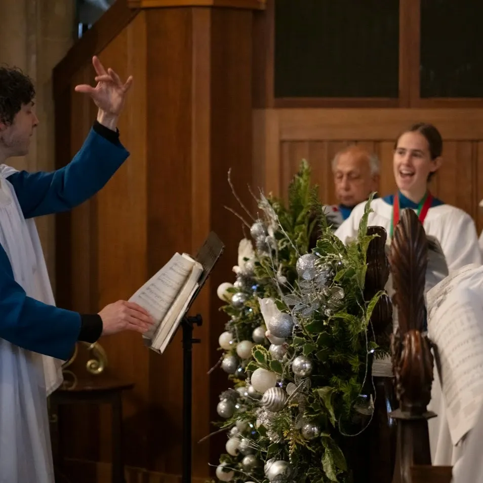 The choir and director singing at a service in St John's Church